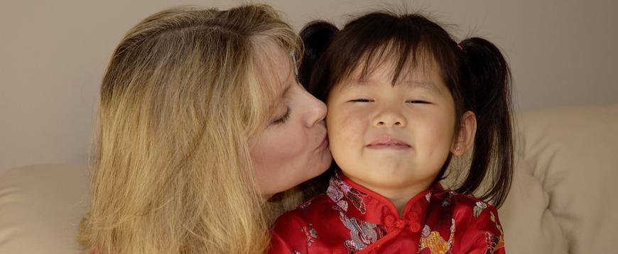 this image shows a mother with her newly adopted chinese daughter.
